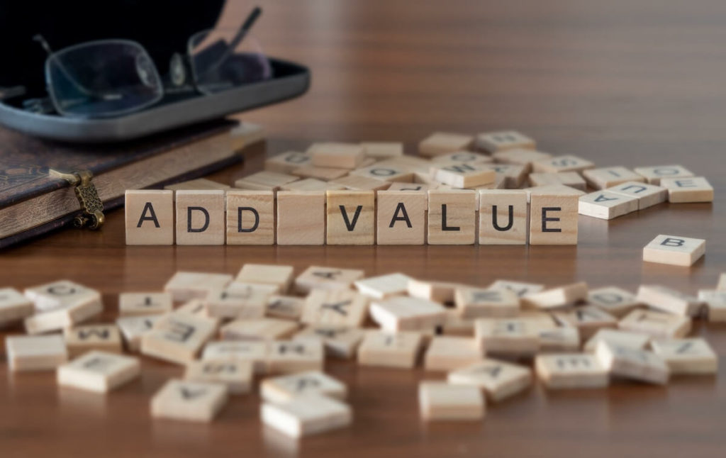 Small business broker: ADD VALUE spelled using wooden scrabble tiles
