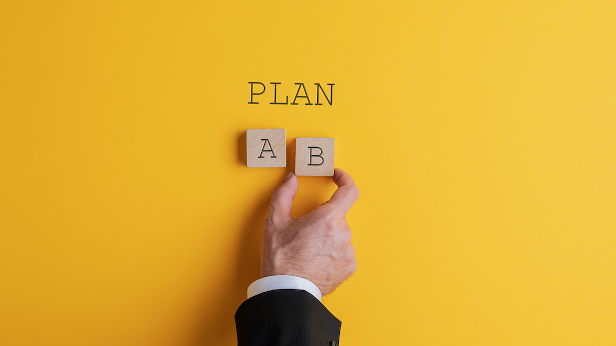 Business exit strategy: person choosing between Plan A and B blocks