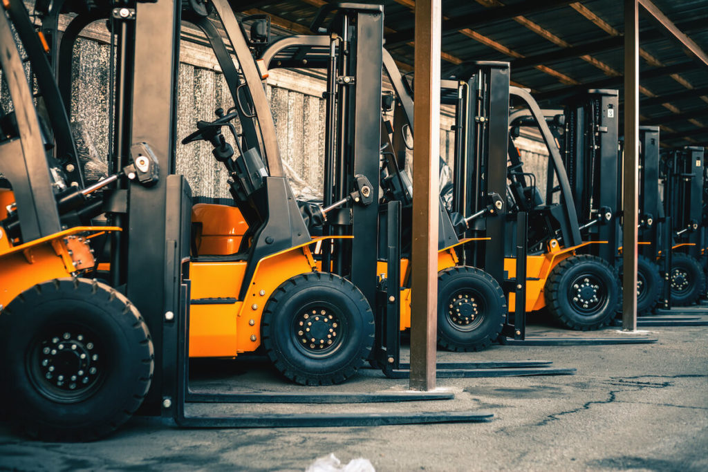 How to price your business for sale: lined-up forklifts