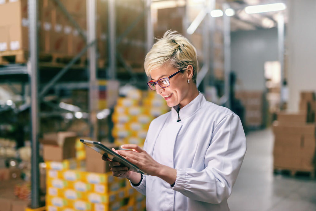 What is EBITDA: entrepreneur using a tablet inside a warehouse